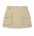 Malbon women's solid pleated golf skort with pockets in Khaki, front view