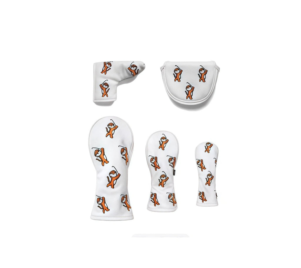Full view of a complete white golf headcover collection featuring cartoon tigers in action poses, including driver, fairway, hybrid, blade putter, and mallet putter covers for full bag protection.