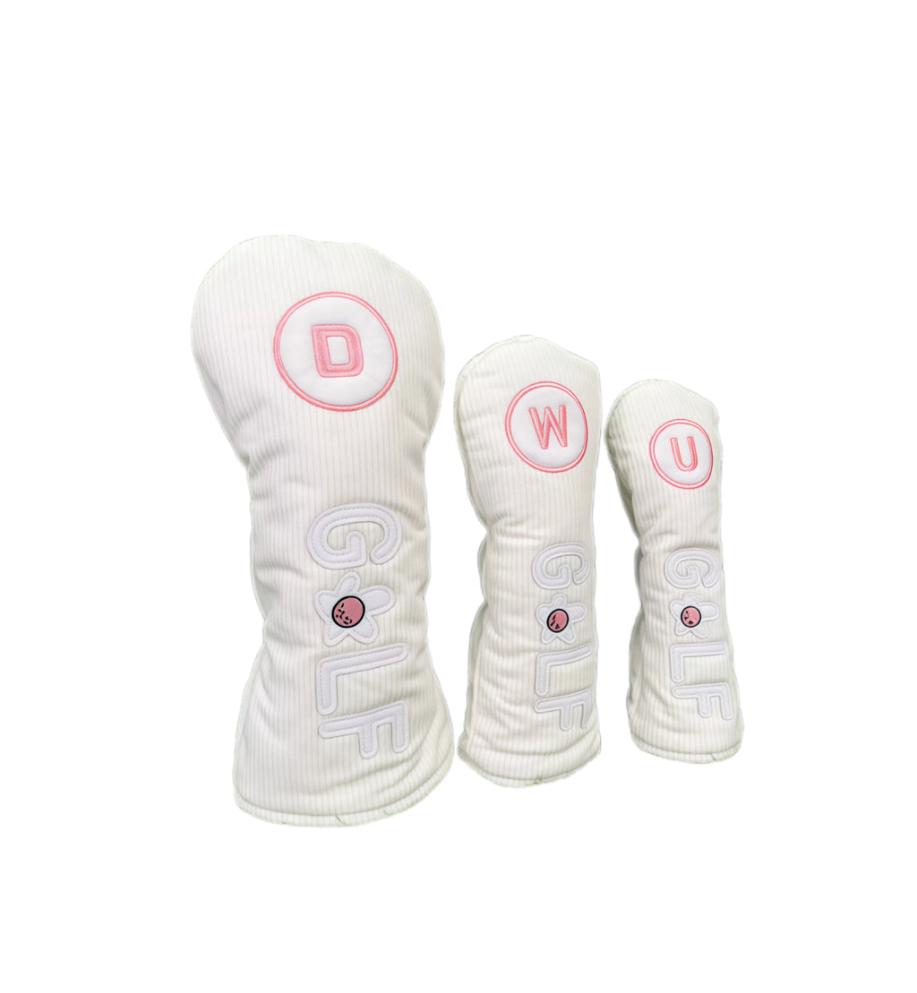 Corduroy golf headcovers set featuring white corduroy material with pink lettering (D, W, U),立体GOLF letters and flower design, compatible with driver, fairway woods and utility clubs.