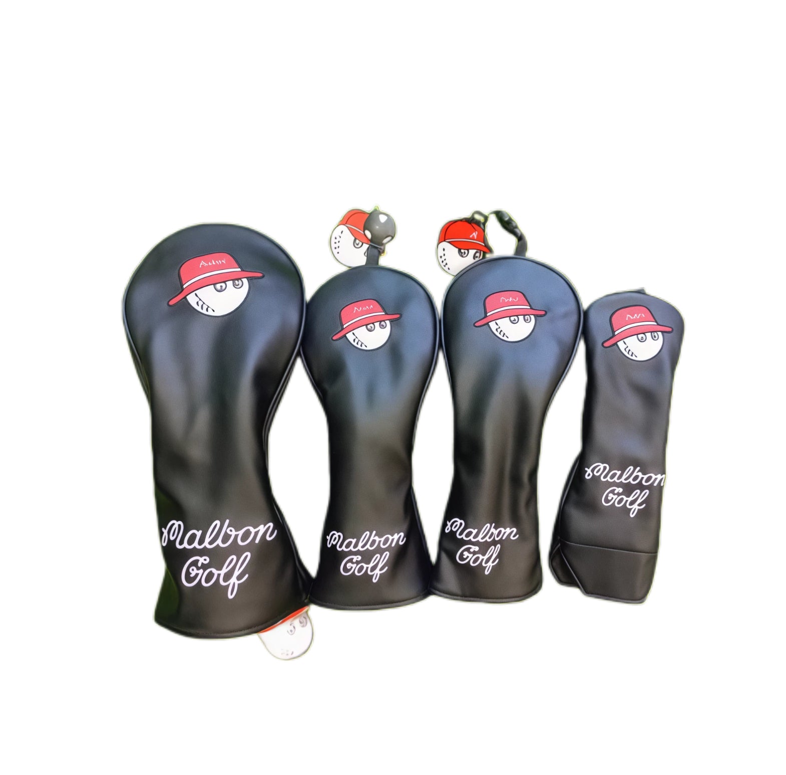 Malbon Golf headcover set featuring four black synthetic leather covers with cute cartoon golf ball face wearing a red bucket hat — includes driver, fairway wood, hybrid, and putter covers with "Malbon Golf" script logo for playful protection and club identification.