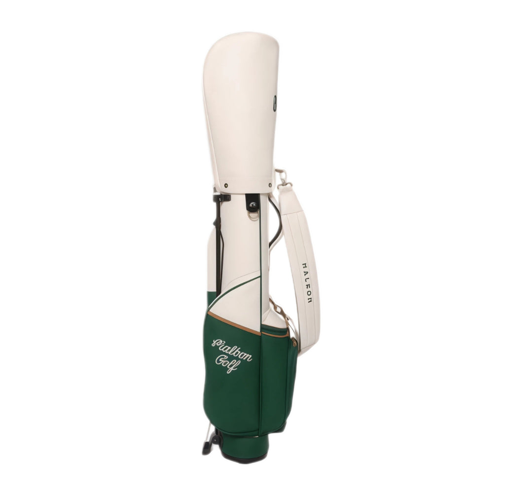 Back view of Malbon Golf "Amongst the Cypress" caddy bag highlighting clean lines, secure zip closure, padded shoulder strap labeled “MALBON”, and lightweight build.