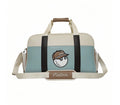 Front view of Malbon Golf Boston bag in light blue and cream PU leather, featuring cartoon golf ball wearing cap, dual top handles, and adjustable shoulder strap