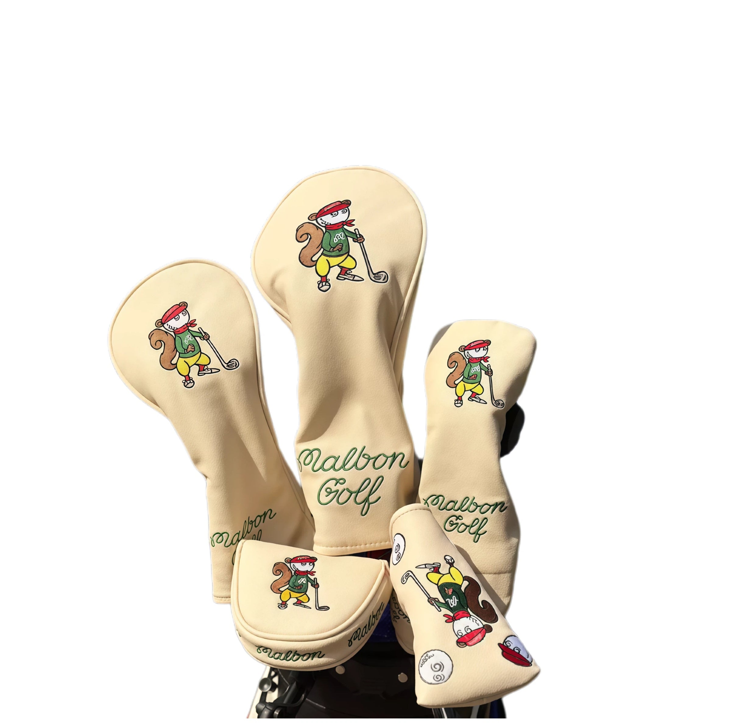 Beige Malbon Golf squirrel-themed headcover set featuring playful cartoon squirrels holding golf clubs — includes driver, fairway wood, hybrid, and mallet putter covers with magnetic closure and waterproof PU material for durable protection.