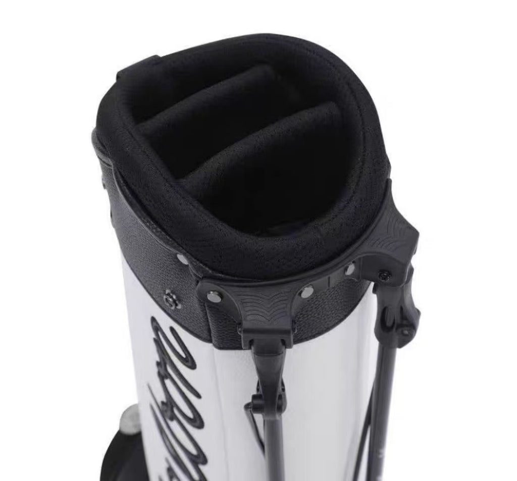 Close-up of a white and black golf bag with a visible brand logo on a white background