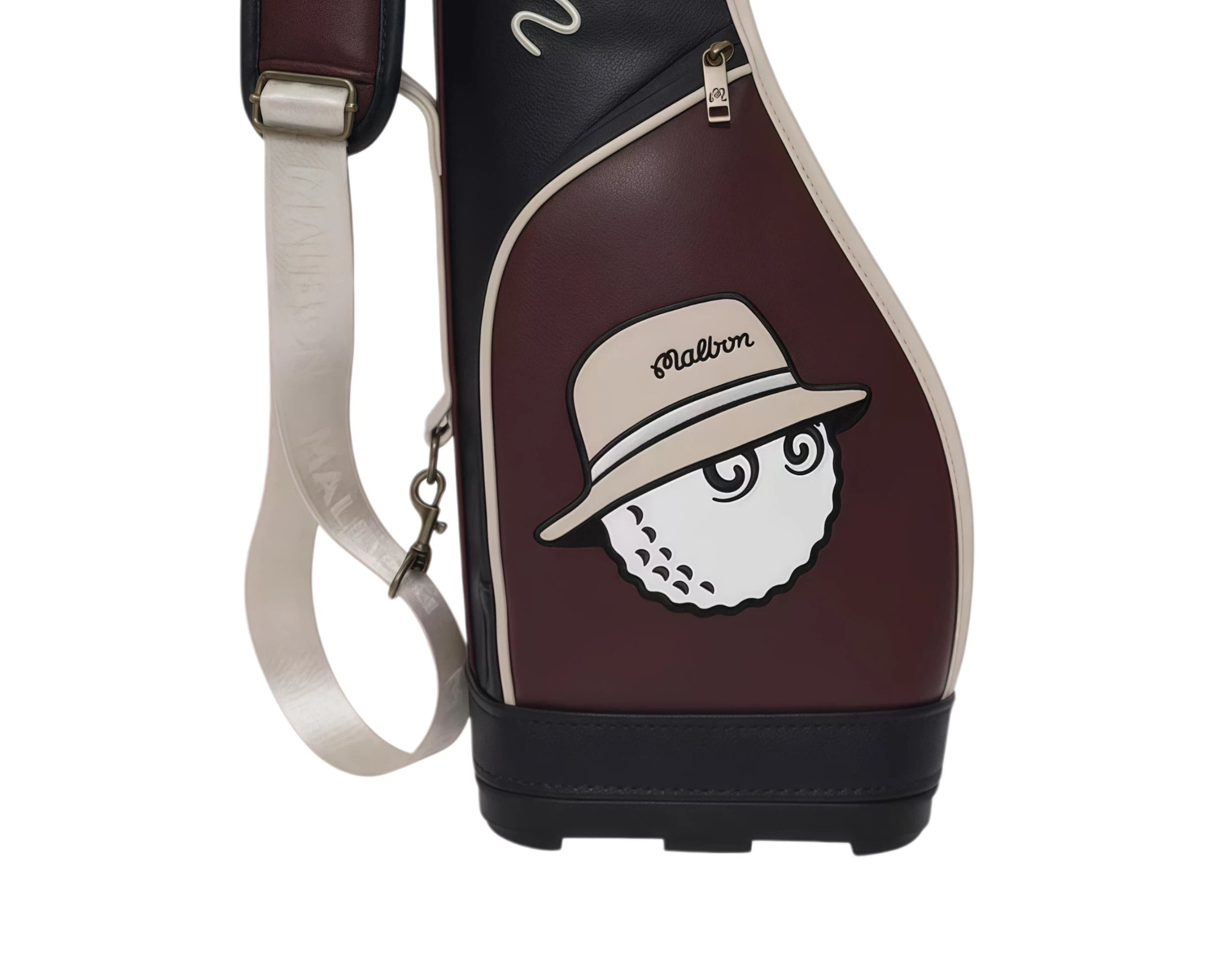 Front close-up of Malbon Golf Classic Sunday bag showcasing embroidered golf ball mascot wearing a beige hat with "Malbon" text. Fun and fashionable detail for golf lovers.