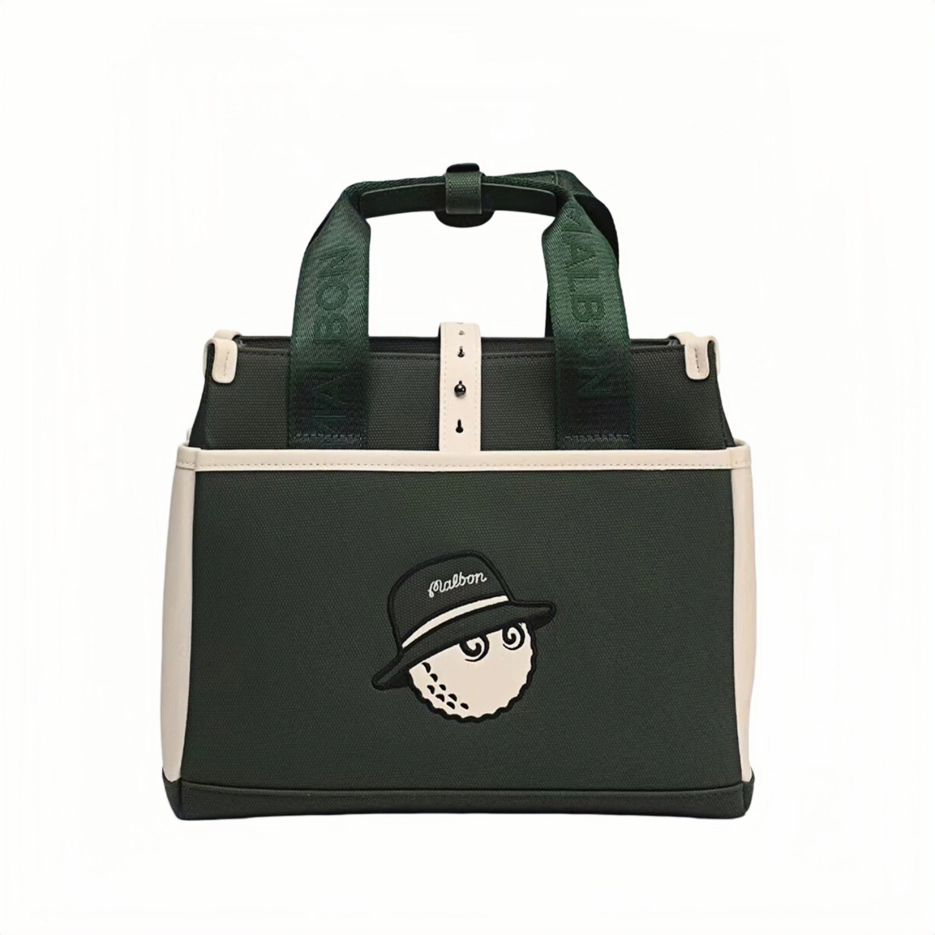  Front view of black Malbon golf tote bag with cream side panels, green woven handles featuring "MALBON" text, and cartoon golf ball character wearing a hat with "Malbon" branding