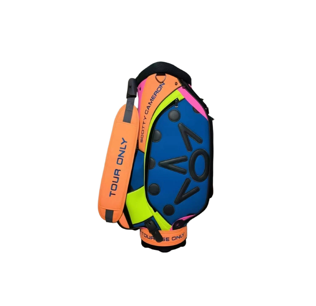Side view of the Scotty Cameron 2023 Tour Bag, emphasizing the neon yellow and pink accents against the blue and orange panels, along with the "SCOTTY CAMERON" branding.