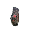 Side view of the Scotty Cameron Pathfinder Camo/Red Stand Bag. This lightweight golf bag features a detailed camouflage pattern with a bold red Circle T logo and "SCOTTY CAMERON MILLED PUTTERS" text in black and red lettering.