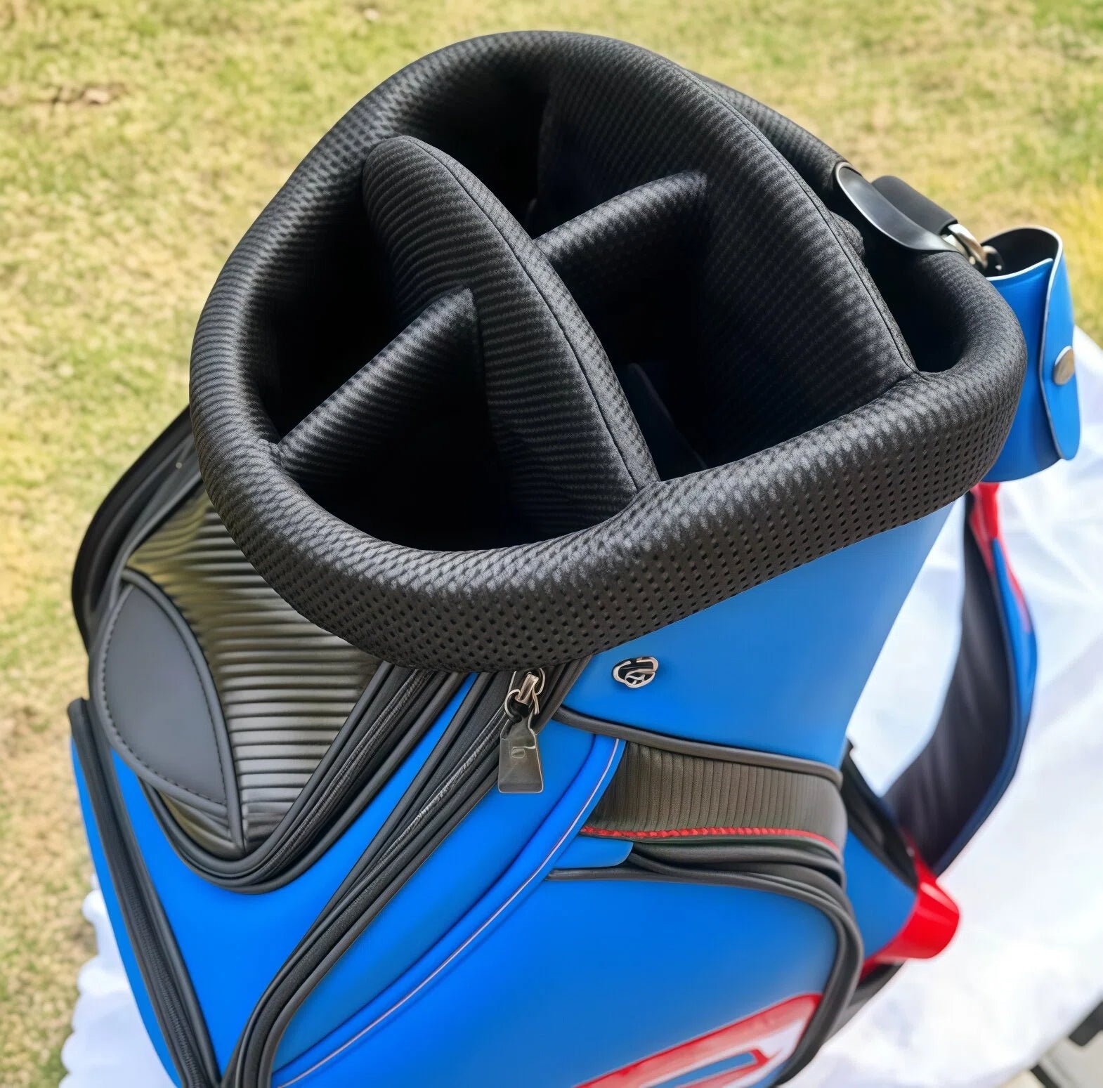Top-down view of the Scotty Cameron Staff Bag's opening, revealing the plush, padded 6-way divider system. The black, textured interior is designed to protect golf clubs and keep them organized during transport.