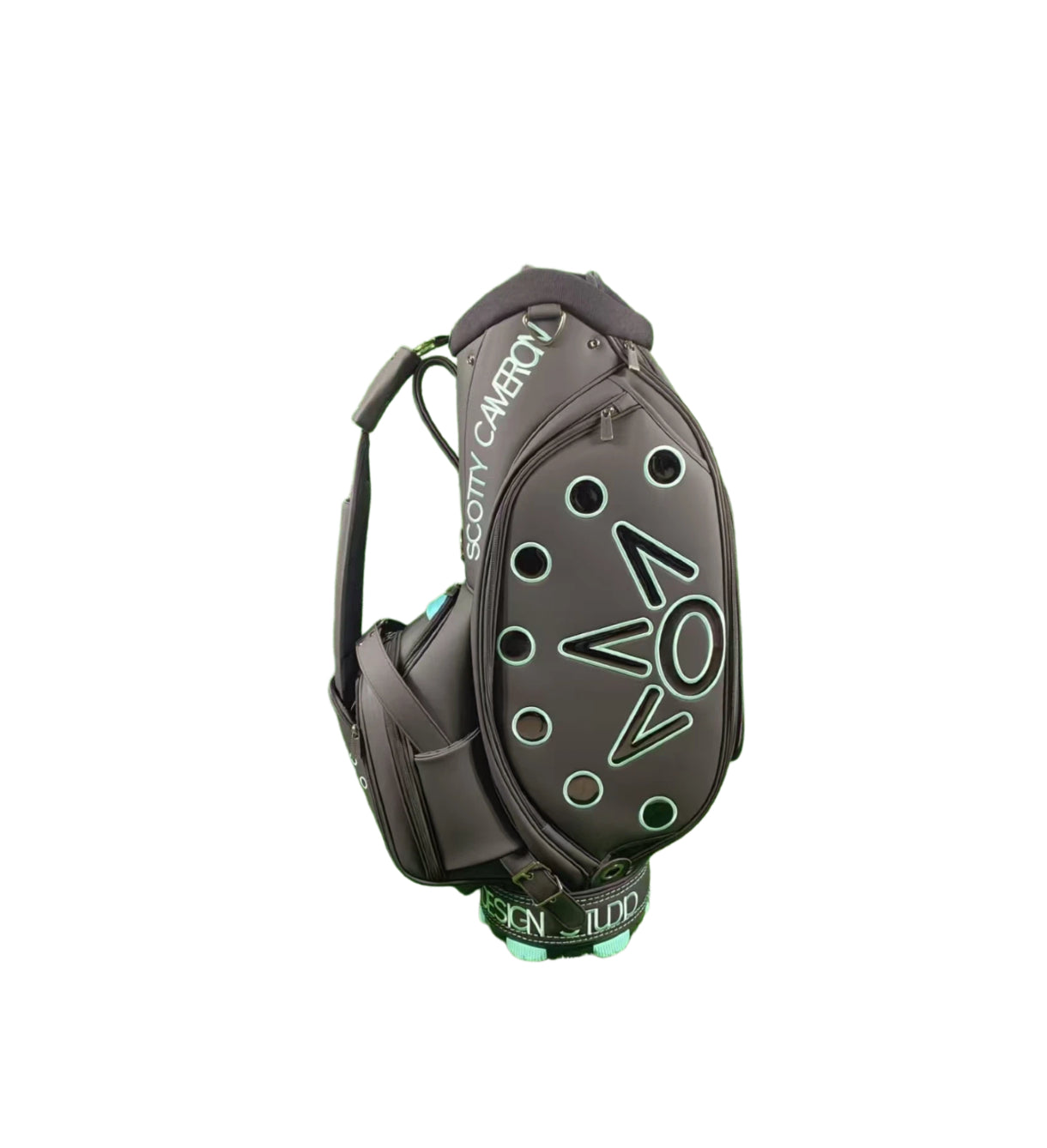 Angled side profile of the Scotty Cameron Supercar Staff Bag, showcasing the large, stylized 'NOV' graphic with light blue outlines and the 'SCOTTY CAMERON' branding on the hood.