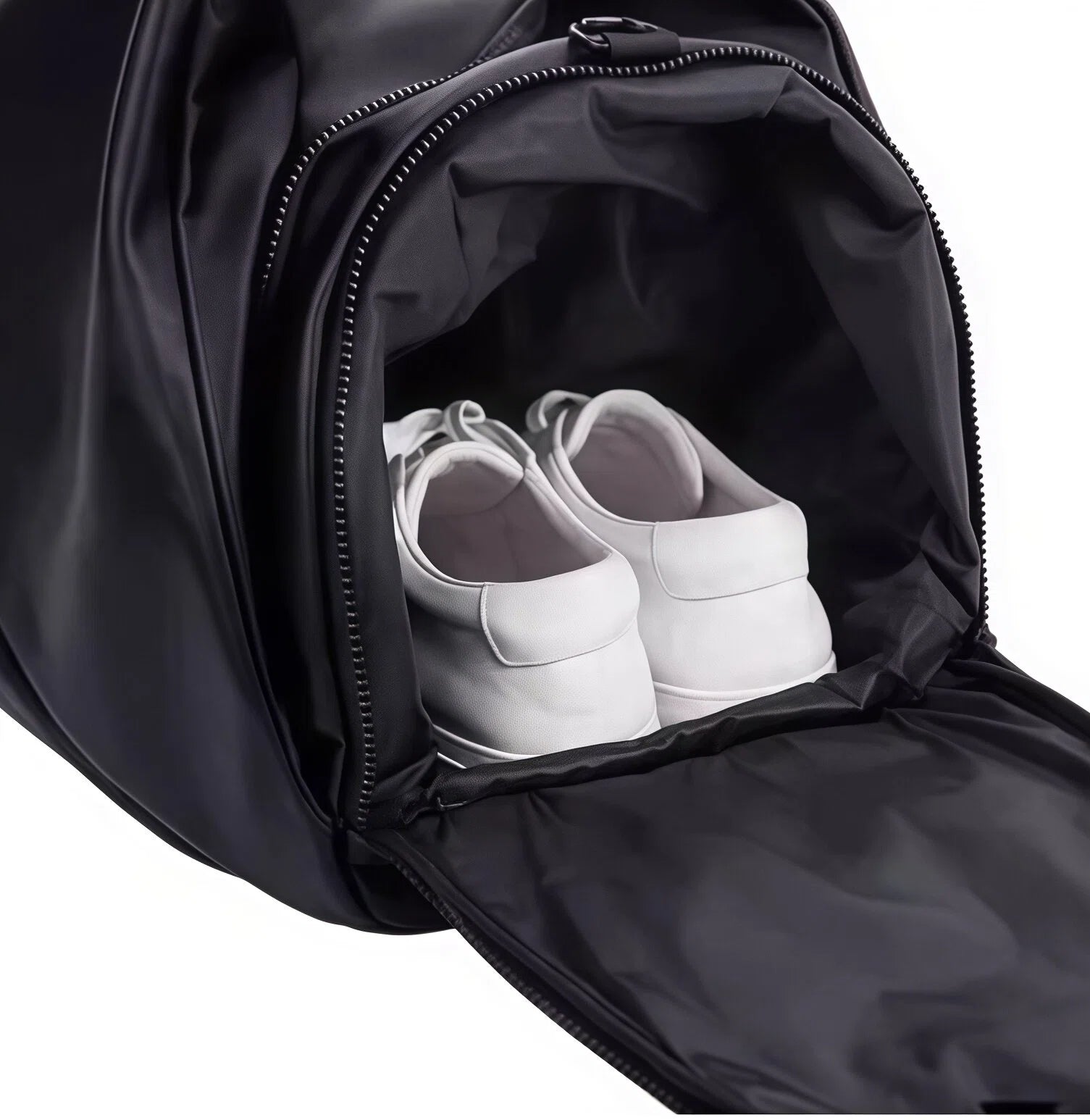 Close-up of the interior shoe compartment in the European Tour duffel bag with a pair of white sneakers neatly stored. Prevents odors and keeps clothes fresh.