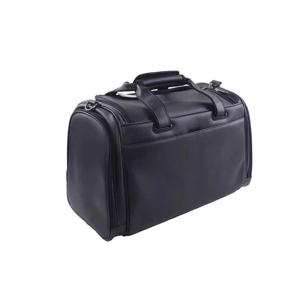 Side view of the Titleist Black Quilted Duffel showcasing its structured shape, top carry handles, and premium synthetic leather material. Designed for elegant travel and golf gear storage.