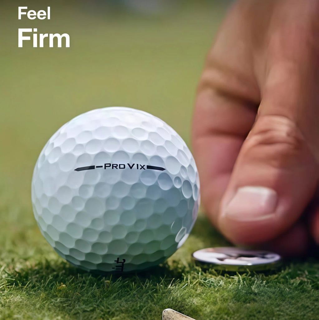 Close-up of a Titleist Pro V1x Left Dash golf ball on grass, highlighting its firm feel and detailed dimple pattern, with a hand and coin for scale, emphasizing its premium construction and performance.