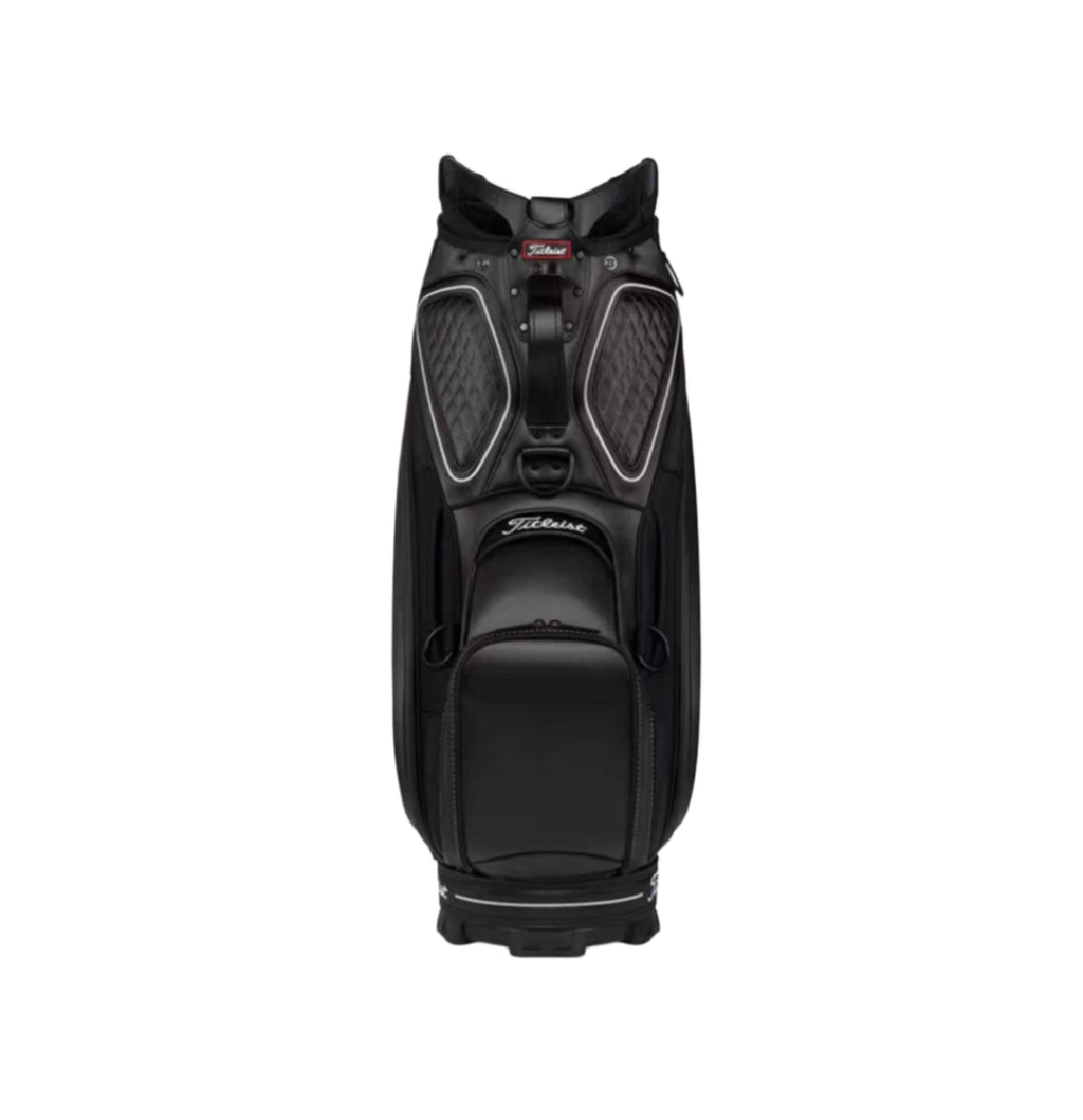 Front view of the all-black Titleist Tour golf bag with white contrast stitching and subtle branding. Designed for sleek performance, this bag features quilted panels, a central zippered pocket, and a sturdy base for stability when placed on the ground.