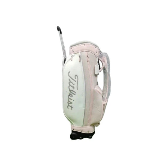 Rear view of the Titleist Waterproof Stand Golf Bag displaying its dual wheels, retractable handle, and light pink and mint color scheme with the Titleist branding on the side pocket.