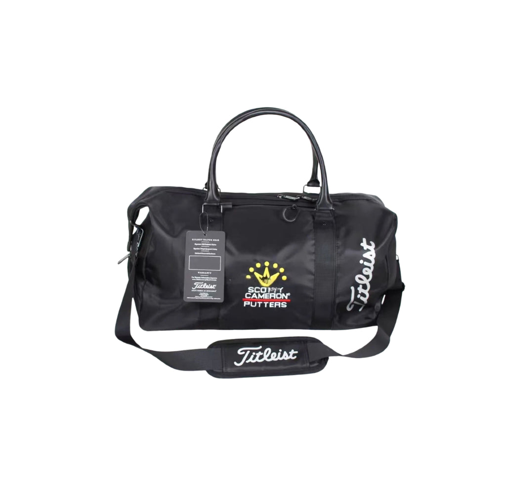 Front view of the black Titleist x Scotty Cameron Duffel Bag featuring the Scotty Cameron crown logo, "Titleist" script on side, and retail tag. Premium limited edition golf travel bag.

